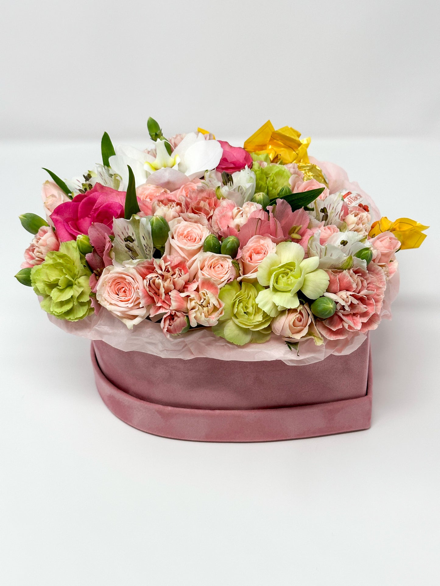 Flowers and candy in a box shaped heart