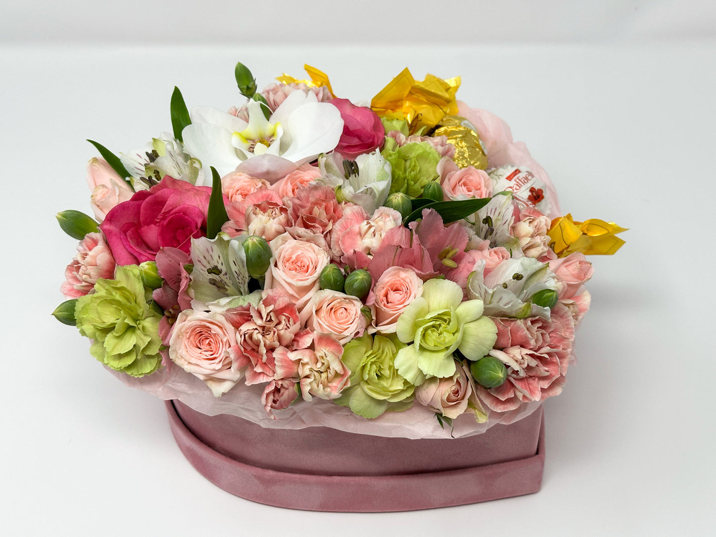 Flowers and candy in a box shaped heart