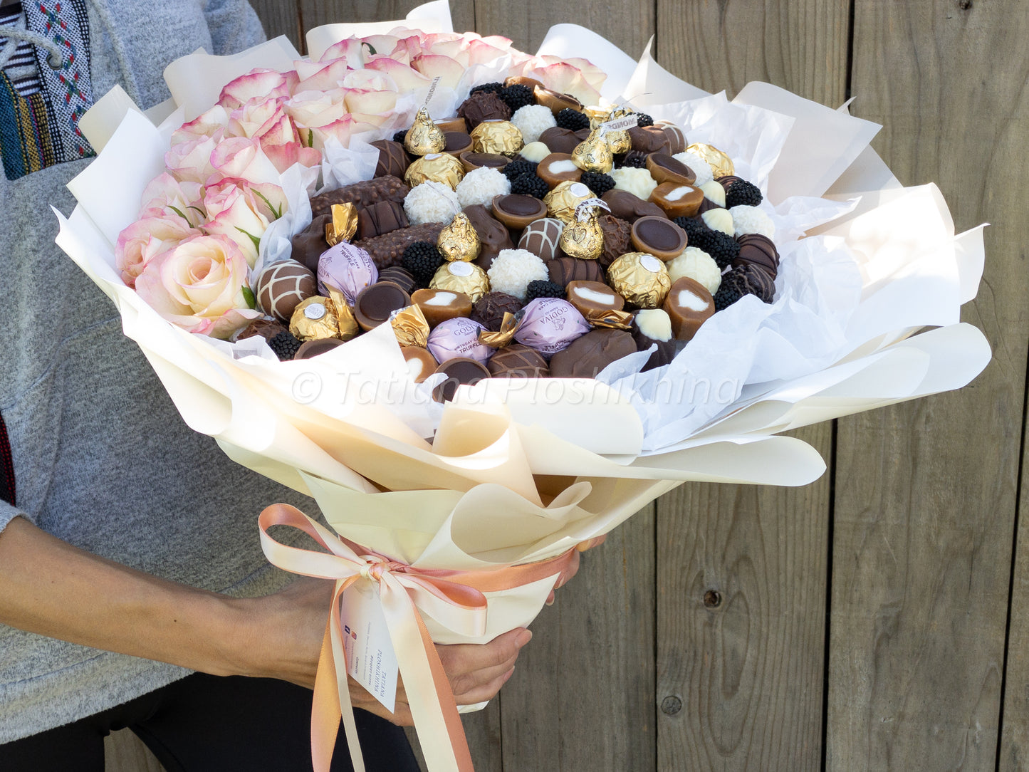 Candies and fresh flowers bouquet