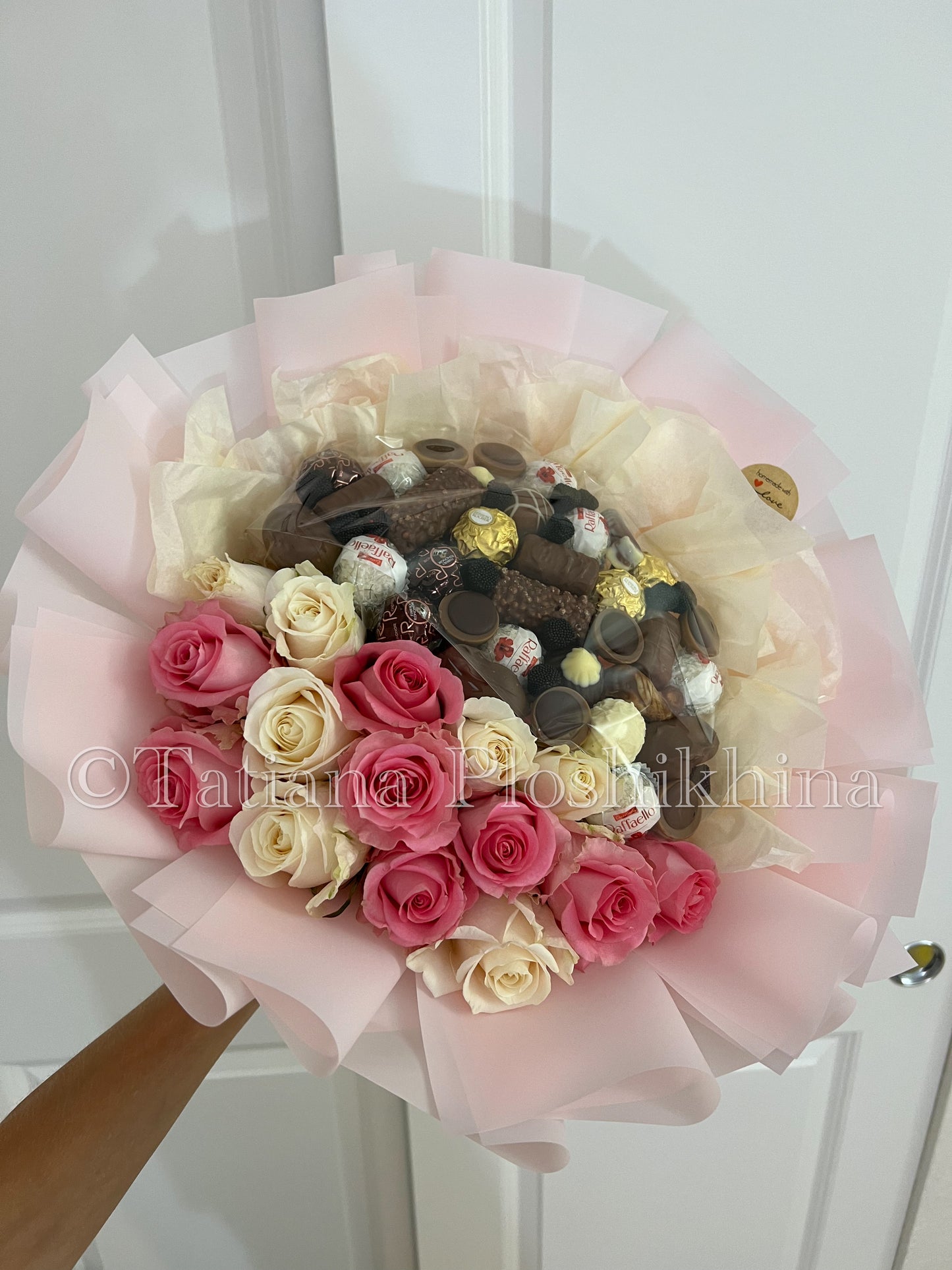 Candies and fresh roses bouquet