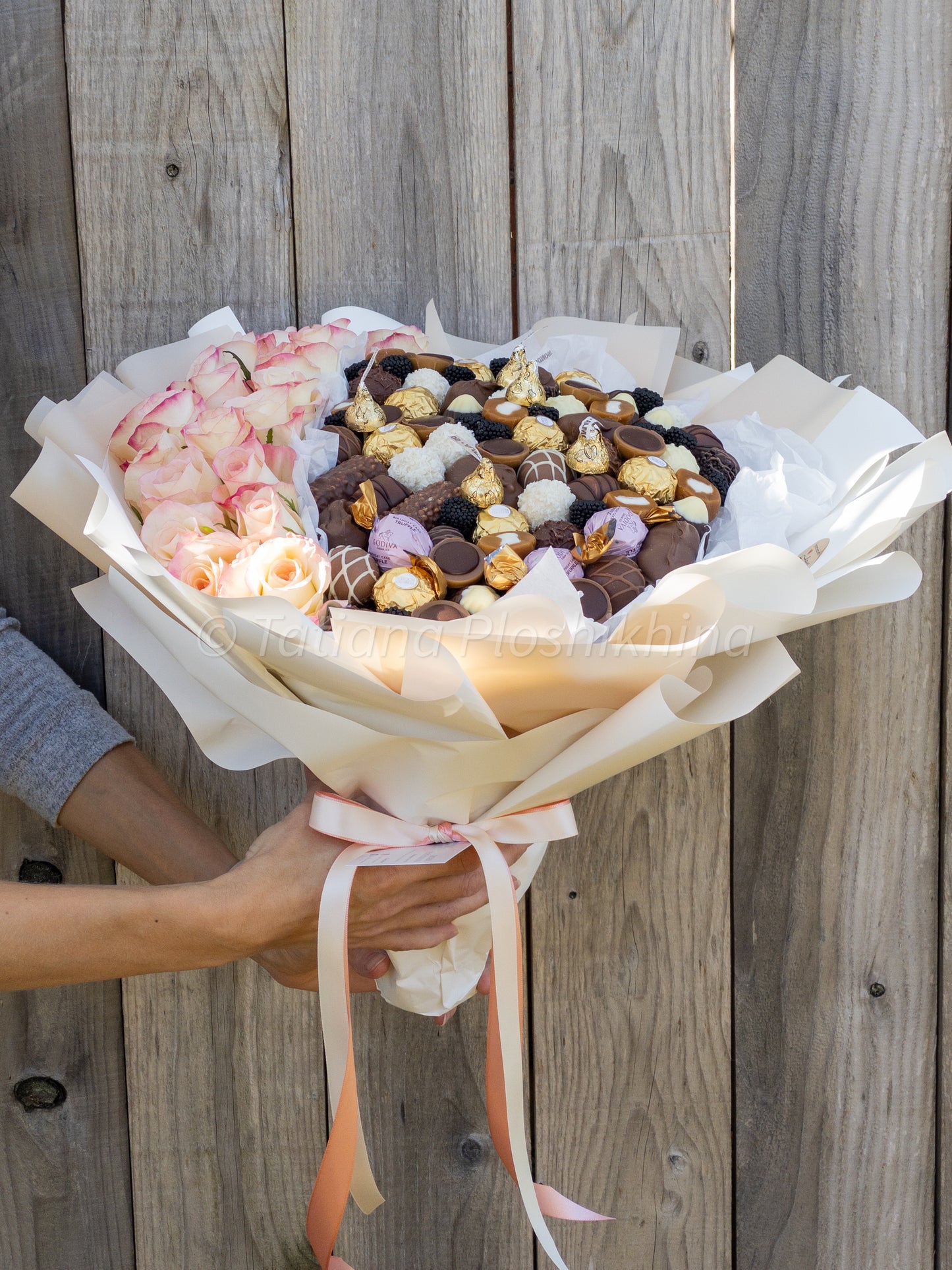 Candies and fresh flowers bouquet