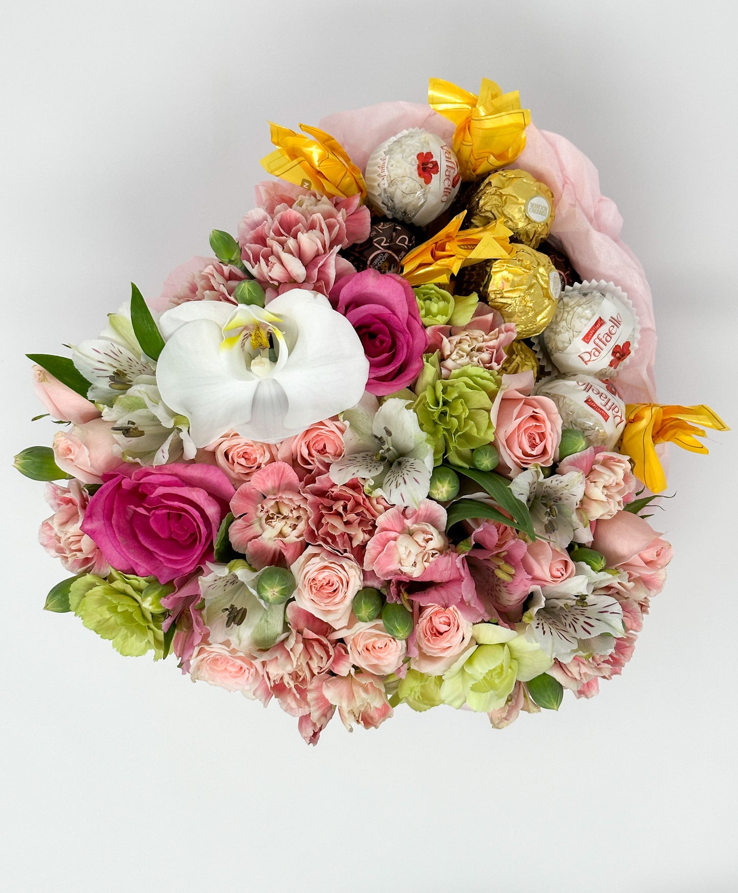 Flowers and candy in a box shaped heart