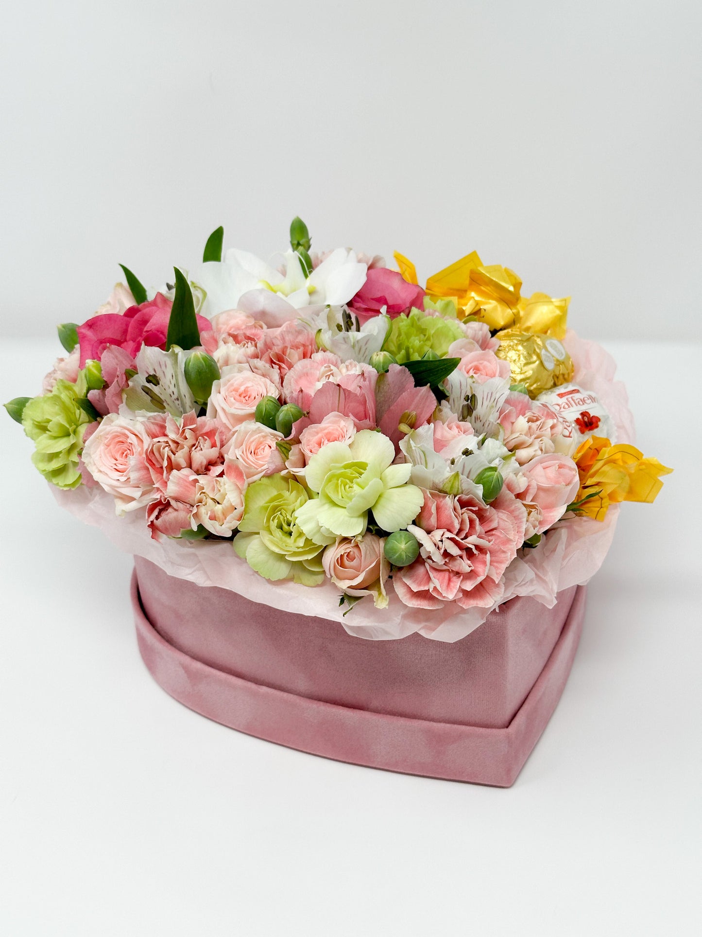 Flowers and candy in a box shaped heart