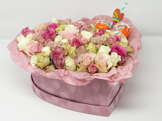 Flowers and kinder chocolate eggs  in a box shape hearts