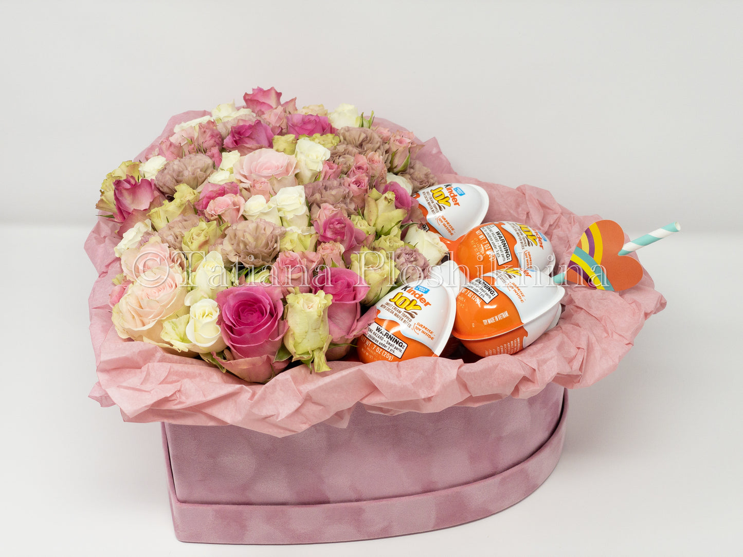 Flowers and kinder chocolate eggs  in a box shape hearts