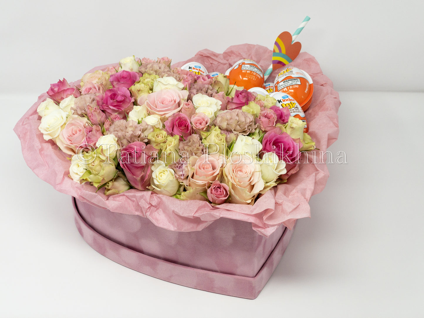 Flowers and kinder chocolate eggs  in a box shape hearts